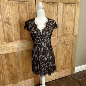 Black cocktail dress with lace detailing.